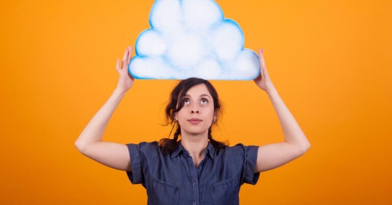 A small business owner holding a cloud icon above her head, symbolizing the exploration of cloud hosting options for enhancing business operations.